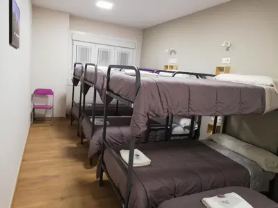 a row of bunk beds in a room at Albergue Camiño Real in Sigüeiro
