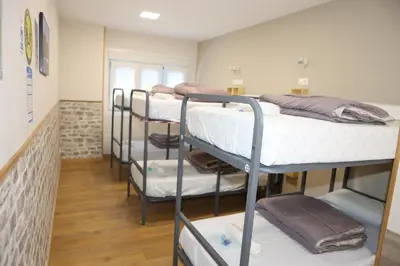 a room with a bunch of bunk beds at Albergue Camiño Real in Sigüeiro