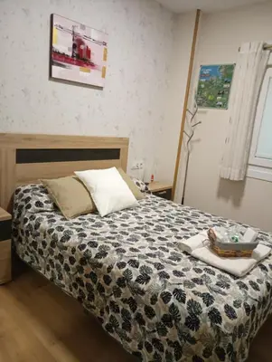 a bedroom with a bed with a tray on it at Albergue Camiño Real in Sigüeiro