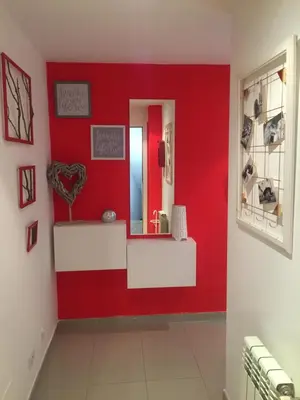 a red bathroom with a mirror and a red wall at Apartamento Centro Frente Muralla in Lugo