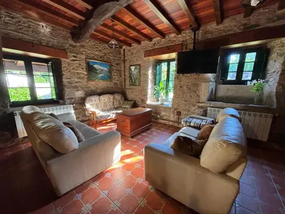 a living room with two couches and a table at Eira de Bergondo in Bergondo