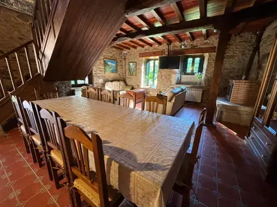 a large dining room with a large table and chairs at Eira de Bergondo in Bergondo