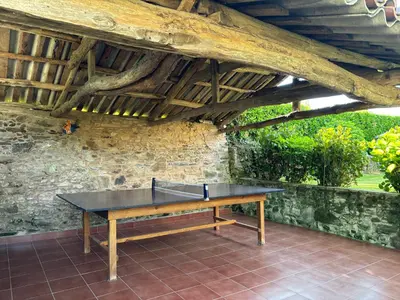 a ping pong table sitting under a wooden ceiling at Eira de Bergondo in Bergondo