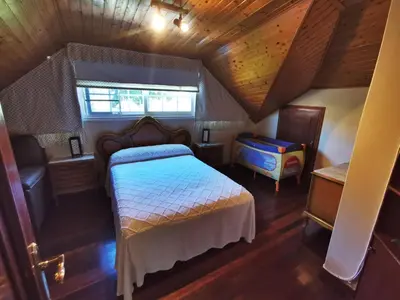 a bedroom with a bed and a wooden ceiling at Casa Duarte in Cuntis