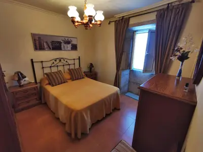 a bedroom with a bed and a window at Casa Duarte in Cuntis