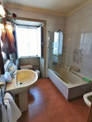 a bathroom with a tub and a sink and a bath tub at Casa Duarte in Cuntis