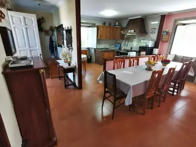a kitchen and dining room with a table and chairs at Casa Duarte in Cuntis