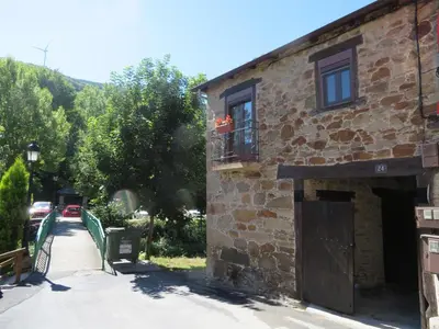 an old brick building with a window and a balcony at Neverending Bierzo in Pobladura de las Regueras