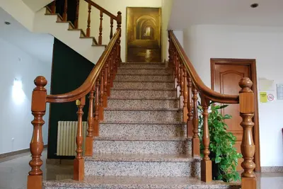 a stairway with a wooden railing and a stair case at Hotel San Jacobo in Santiago de Compostela