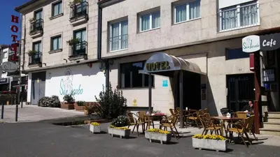 a cafe with tables and chairs in front of a building at Hotel San Jacobo in Santiago de Compostela