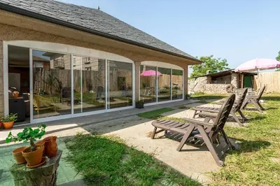 a group of benches sitting outside of a house at Casa Montellos in Betanzos