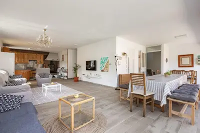 a living room with a table and a couch at Casa Montellos in Betanzos