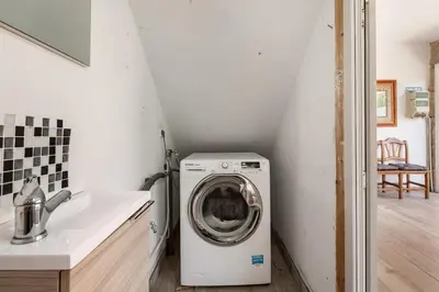 a washer and dryer in a bathroom with a sink at Casa Montellos in Betanzos