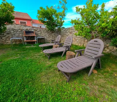 a group of benches sitting in the grass at Casa Montellos in Betanzos