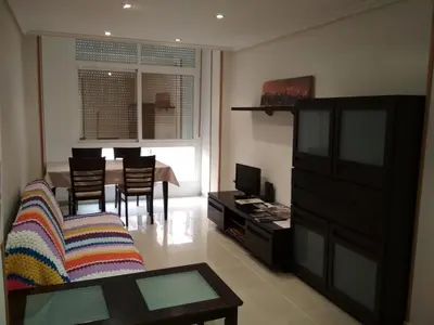 a living room with a couch and a dining room table at Piso Estación Tren Ourense in Ourense