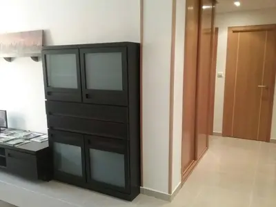 a black dresser sitting in a room next to a door at Piso Estación Tren Ourense in Ourense