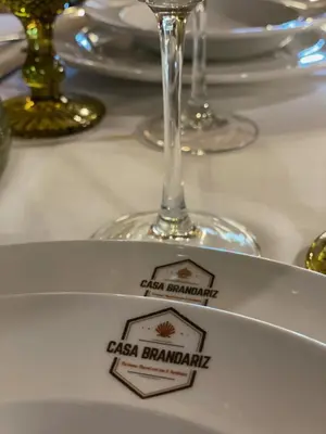 a plate on a table with a wine glass at Casa Brandariz in Santa Maria de Arzua