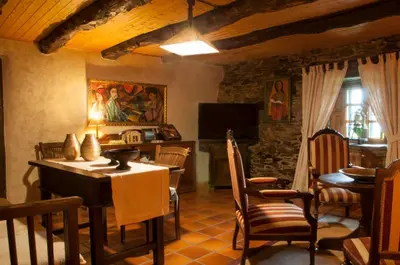 a living room with a table and chairs and a television at Casa Brandariz in Santa Maria de Arzua