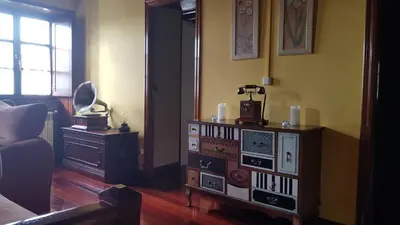 a living room with a dresser with a mirror at Casa Julia De Lozano in Rinlo