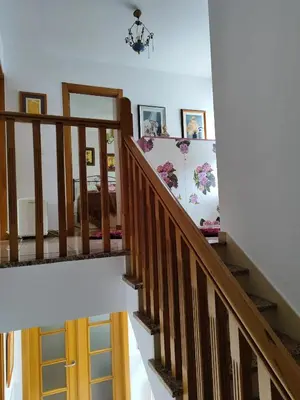 a stairway with a wooden door and pictures on the wall at Charming house in Teo with balcony and parking included in Rua De Francos
