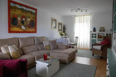 a living room with a couch and a table at Charming house in Teo with balcony and parking included in Rua De Francos