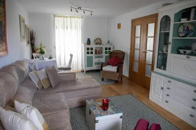 a living room with a couch and a table at Charming house in Teo with balcony and parking included in Rua De Francos