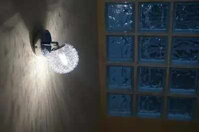a light fixture on a wall with a window at Duplex Ribadeo in Ribadeo
