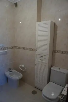 a bathroom with a white toilet and a sink at Duplex Ribadeo in Ribadeo