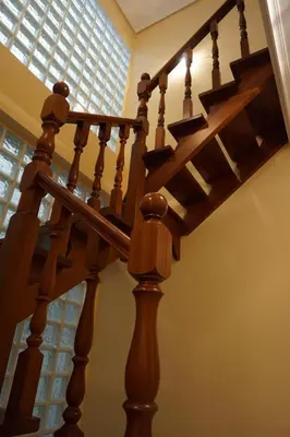 a wooden staircase in a house with a window at Duplex Ribadeo in Ribadeo