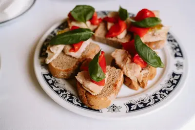 a plate of food with sandwiches on a table at Casa Rural Rectoral de Armariz in Nogueira de Ramuin