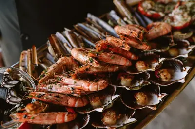 a tray of lobsters and other food on a table at Casa Rural Rectoral de Armariz in Nogueira de Ramuin