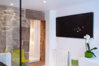 a living room with a flat screen tv on a wall at Green Home in Santiago de Compostela