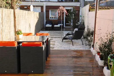 a patio with some chairs and a table and someitures at Green Home in Santiago de Compostela