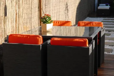 a table with orange chairs and a plant on it at Green Home in Santiago de Compostela