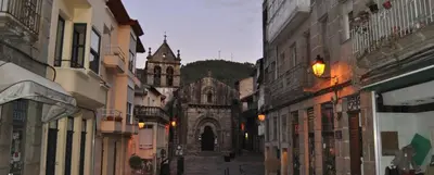 an old building with a church in the middle of a street at Piso Mónica in Ribadavia