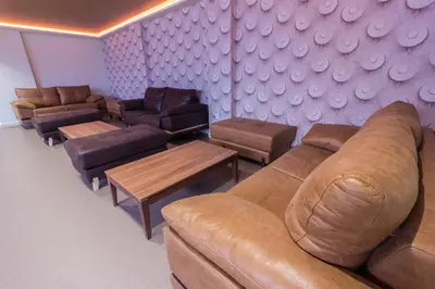 a living room with a couch and tables and chairs at Hotel Novo Cándido in Ourense