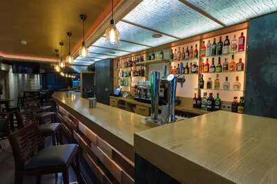 a bar with a wooden counter in a restaurant at Hotel Novo Cándido in Ourense