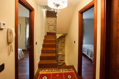 a hallway with a stairway leading to a room at Casa Do Bosque in Sarria