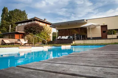 a house with a swimming pool in front of a house at Casa Do Bosque in Sarria