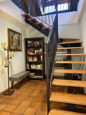 a staircase with a bench and a book shelf at El Balcón De Muniellos in Oballo