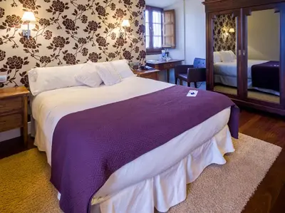 a bedroom with a large bed with a purple blanket at Casa de Castro in Cartavio