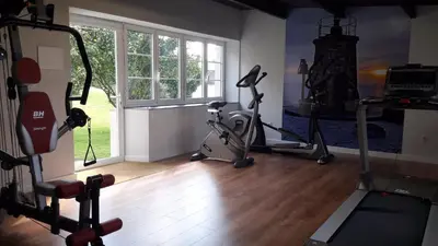 a room with a gym with exercise equipment and a window at Casa de Castro in Cartavio