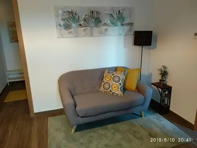 a couch with pillows on it in a living room at A Casiña de Esther in Teo