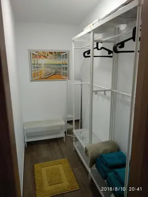 a walk in closet with glass shelves and a painting at A Casiña de Esther in Teo