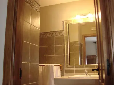 a bathroom with a sink and a mirror at Hotel rural La Campanona in Villager de Laciana