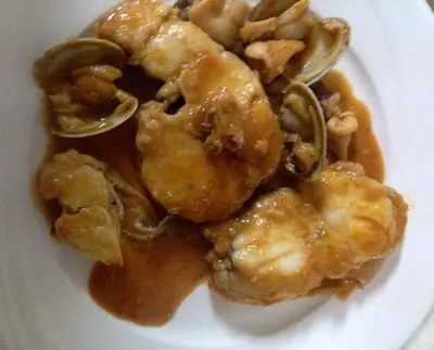 a white plate of food with shrimp and mushrooms at Hotel rural La Campanona in Villager de Laciana