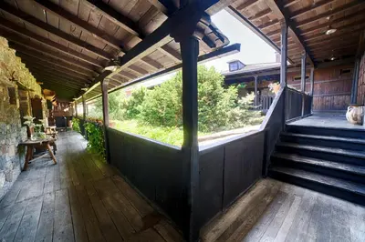 a porch of a house with stairs and a window at La Moncloa de San Lazaro in Cacabelos