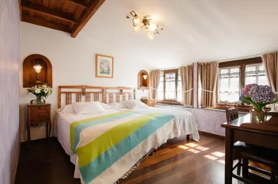 a bedroom with a bed with a colorful blanket at La Moncloa de San Lazaro in Cacabelos