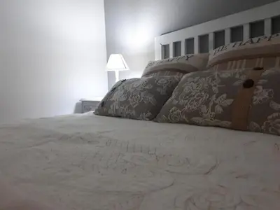 a bedroom with a bed with pillows on it at Piso Camino de Santiago 2 in Sarria