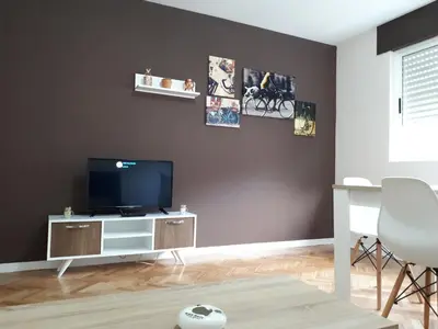 a living room with a flat screen tv on a wall at Piso Camino de Santiago 2 in Sarria